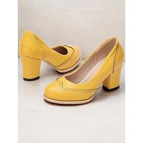 Gele vintage-geïnspireerde dameshakken met brogue-details, dikke hak en instapmodel, perfect voor werkkleding en speciale gelegenheden